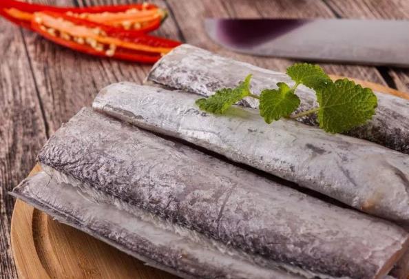 帶魚清洗：解凍、剪去頭部和魚鰭，剪開魚肚切段，掏內臟用水洗凈